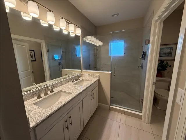 a white toilet sitting next to a bathroom sink