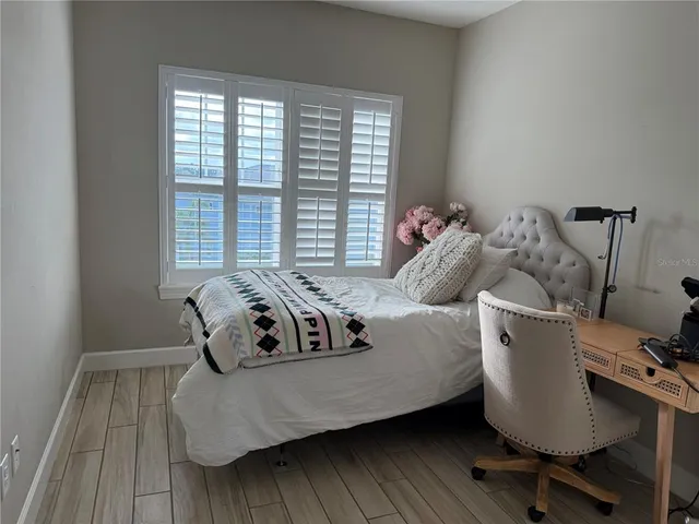 a bedroom with a bed and a couch