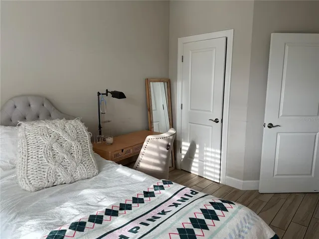 a bathroom with a granite countertop toilet sink and mirror