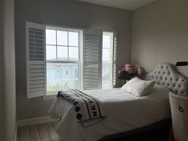 a bed sitting in a bedroom next to a window