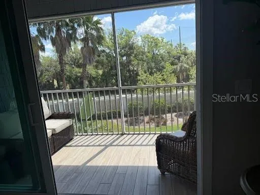 a balcony with furniture and wooden floor