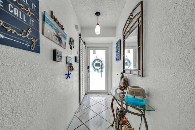 a view of a hallway with seating area