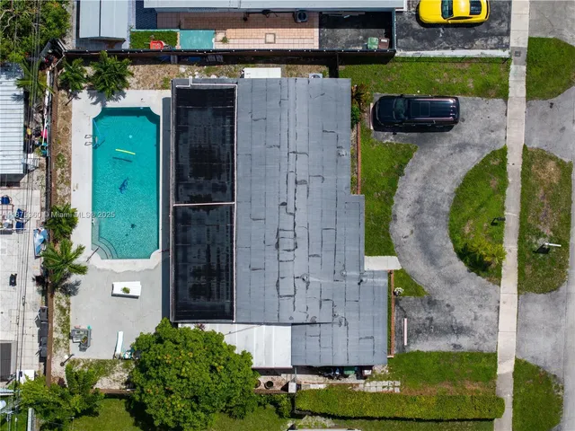 an aerial view of a house with a swimming pool