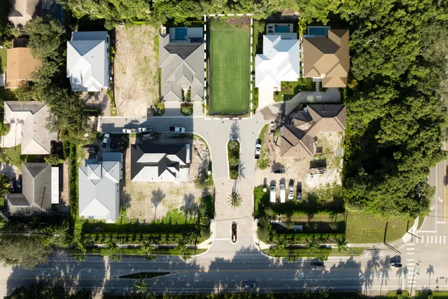 an aerial view of multiple houses with yard