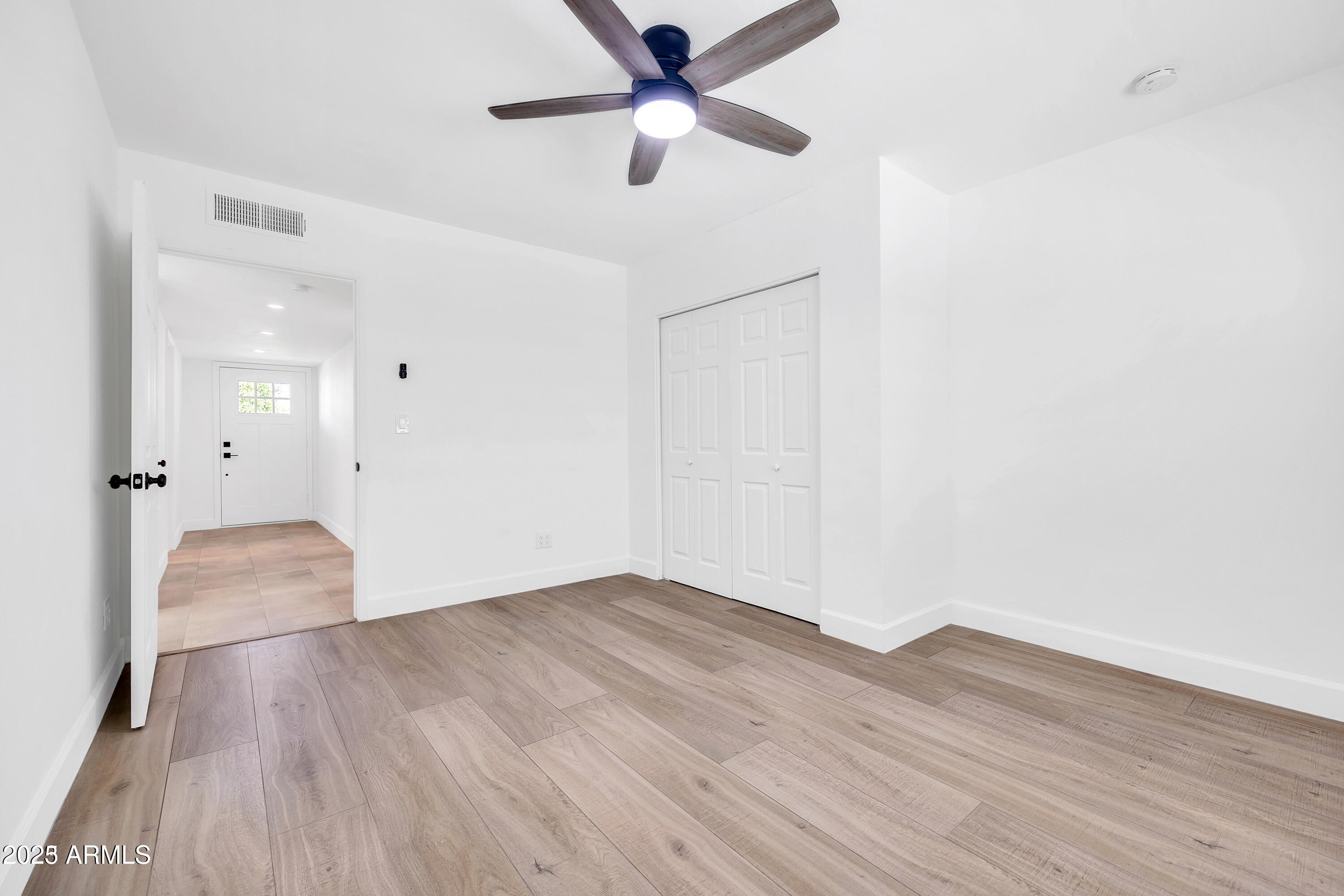 1107 East Marlette Avenue Phoenix, AZ 85014 - Photo 17 of 28 a view of empty room with wooden floor