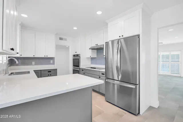 a kitchen with stainless steel appliances a refrigerator and a sink