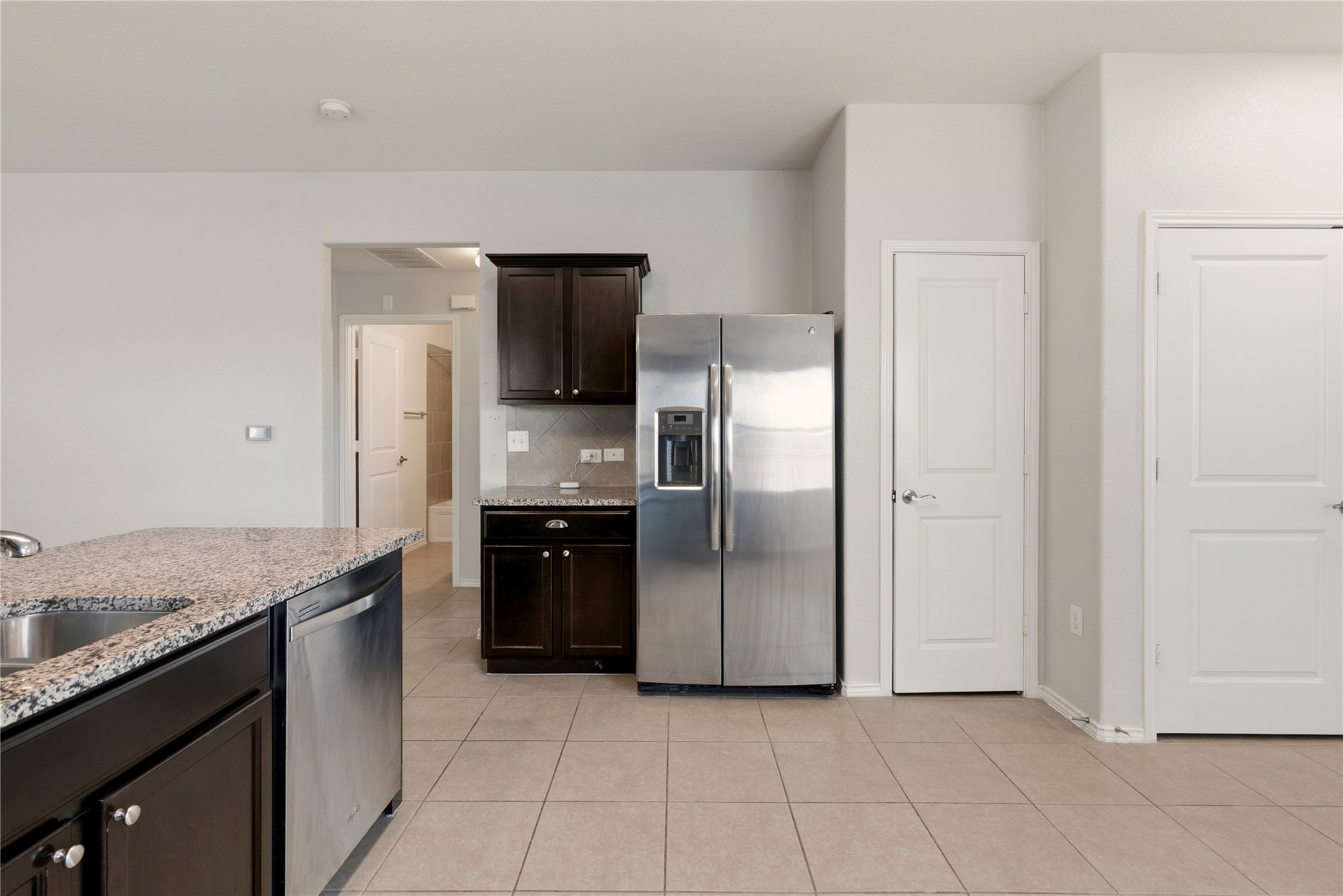 3721 Alpine Autumn Drive Austin, TX 78744 - Photo 13 of 29 a kitchen with a refrigerator and a sink
