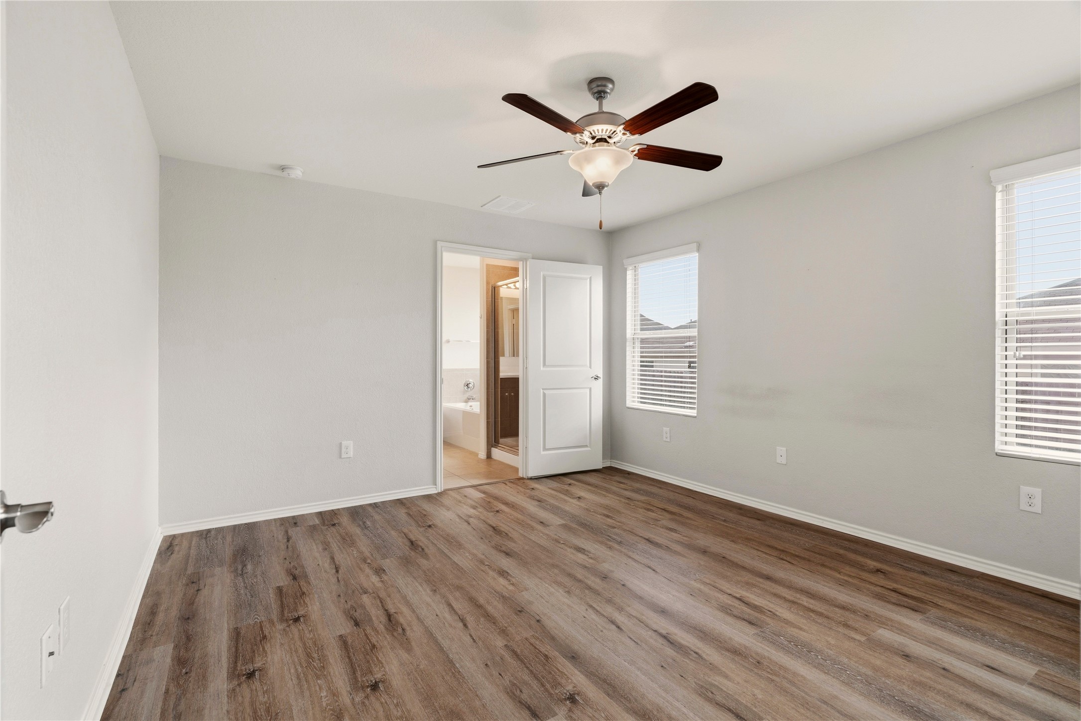 3721 Alpine Autumn Drive Austin, TX 78744 - Photo 17 of 29 a view of a big room with wooden floor closet and windows