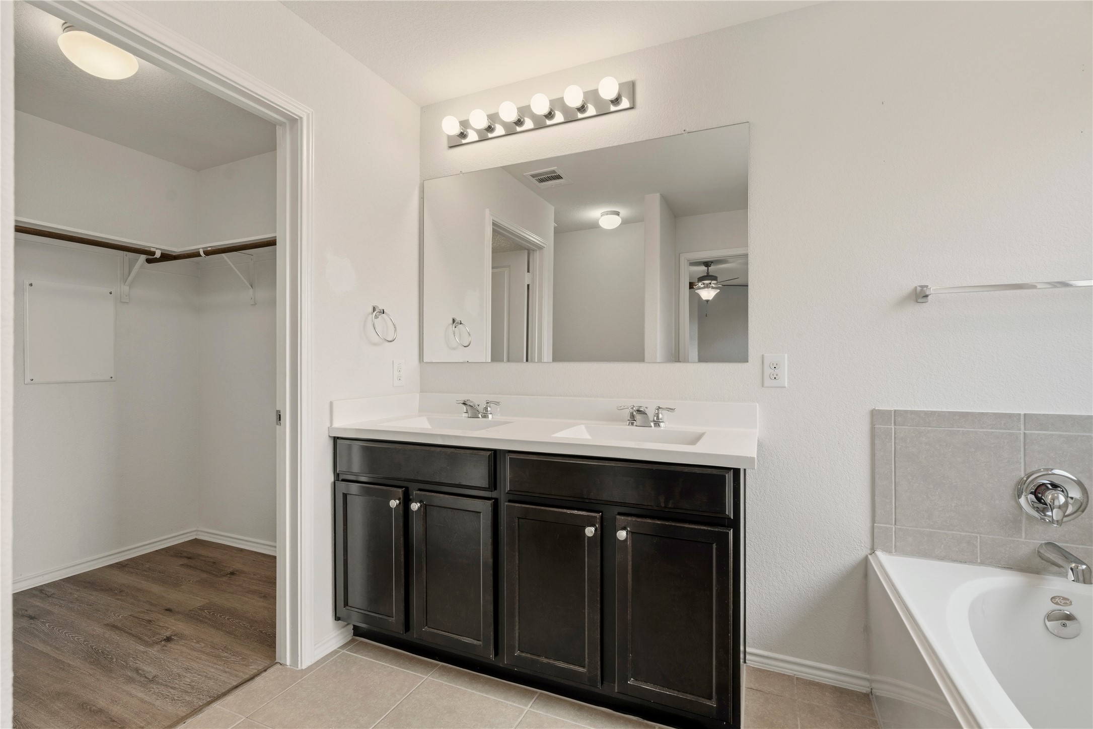 3721 Alpine Autumn Drive Austin, TX 78744 - Photo 18 of 29 a bathroom with a double vanity sink mirror and bathtub