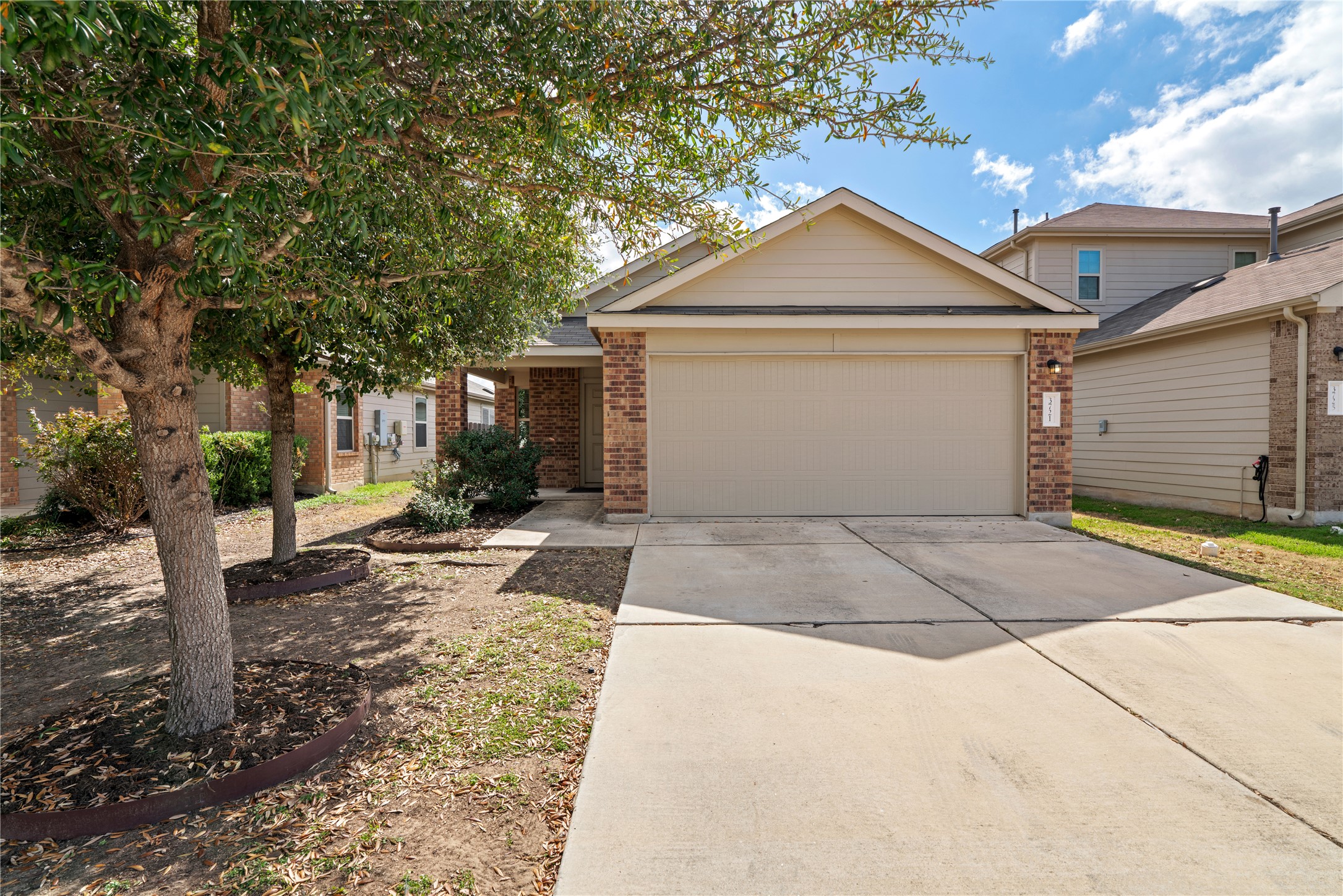 3721 Alpine Autumn Drive Austin, TX 78744 - Photo 2 of 29 a view of garage yard and garage