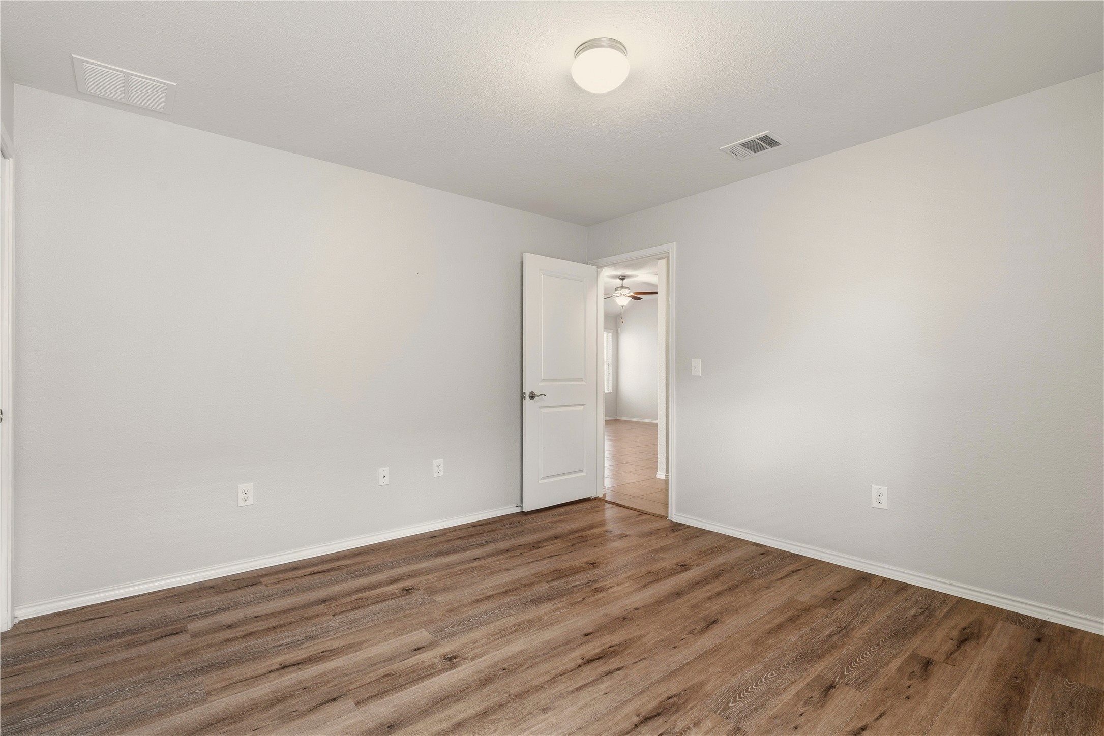 3721 Alpine Autumn Drive Austin, TX 78744 - Photo 22 of 29 a view of an empty room and wooden floor