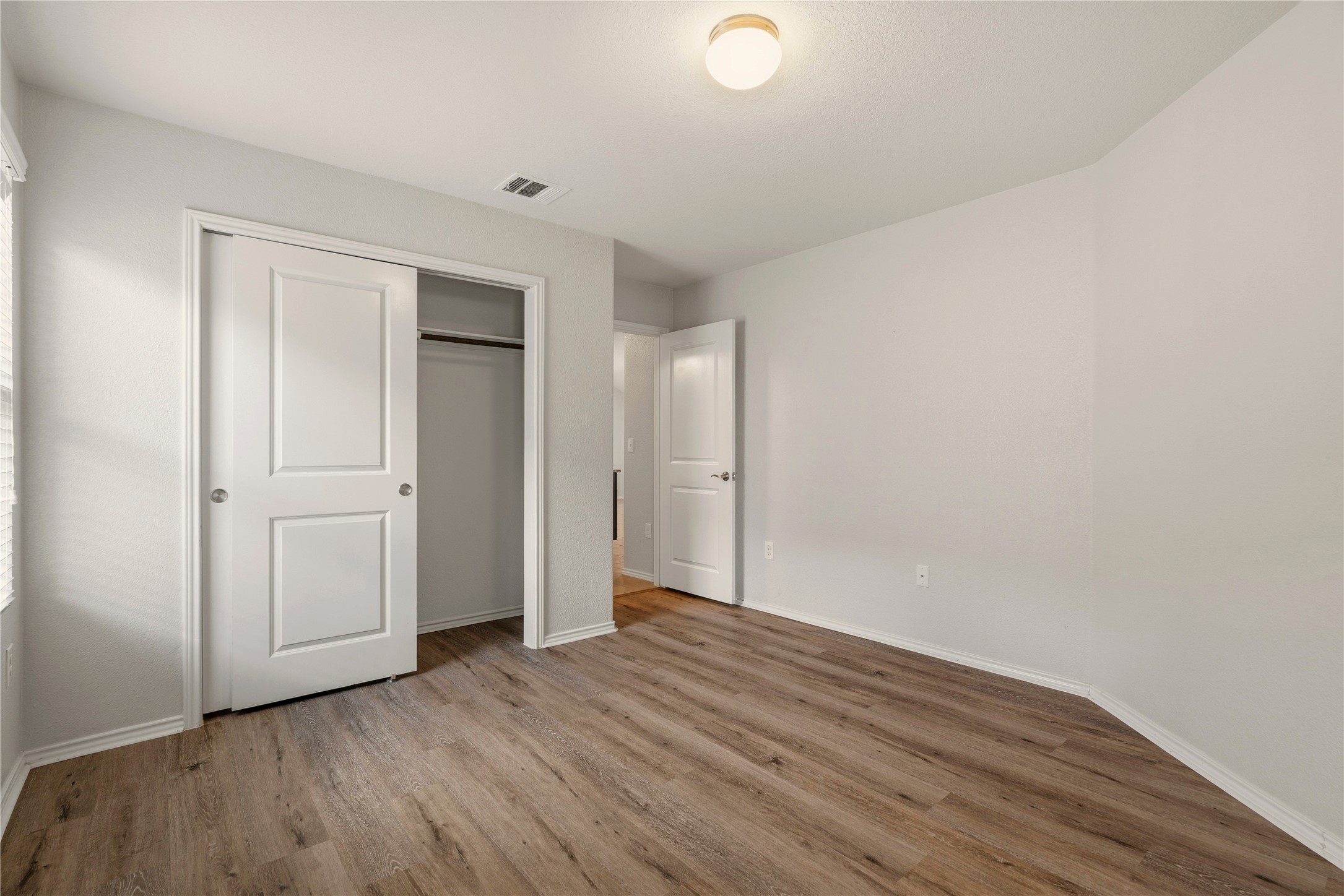 3721 Alpine Autumn Drive Austin, TX 78744 - Photo 24 of 29 a view of wooden floor and windows in a room