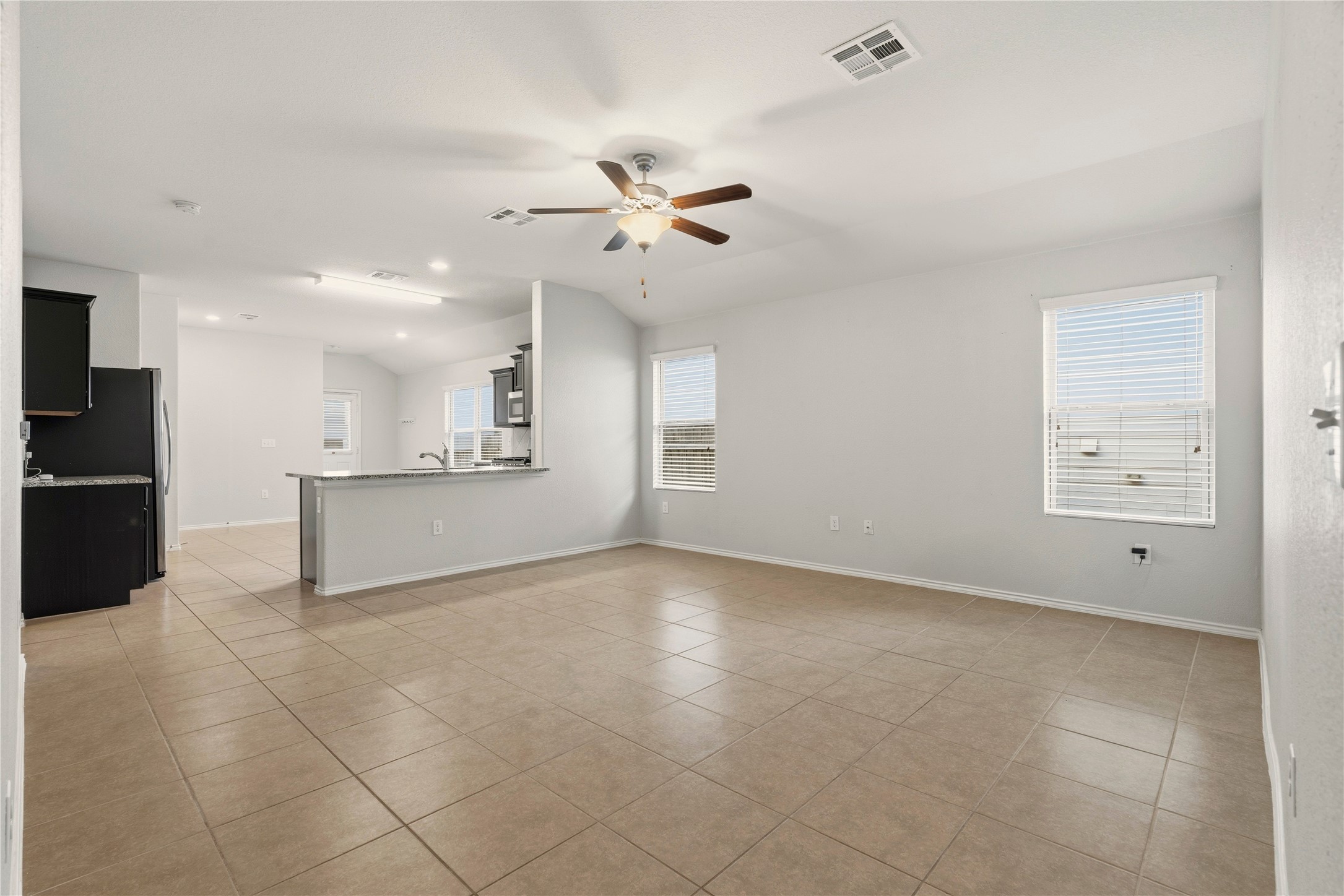 3721 Alpine Autumn Drive Austin, TX 78744 - Photo 6 of 29 a view of an empty room with a kitchen