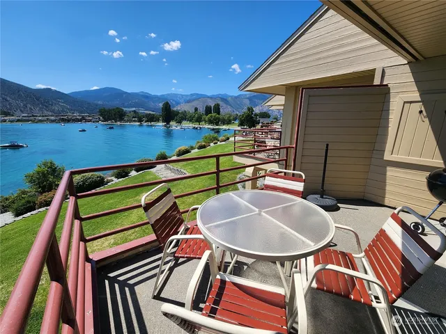 a balcony with table and chairs