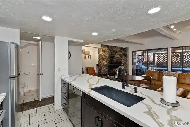 a kitchen with a sink appliances and a counter top space