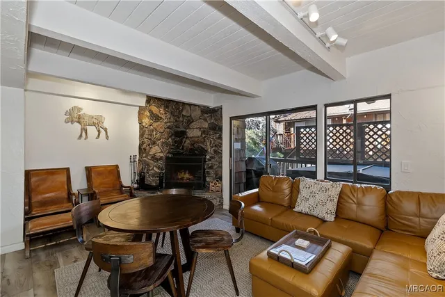 a living room with furniture and a floor to ceiling window