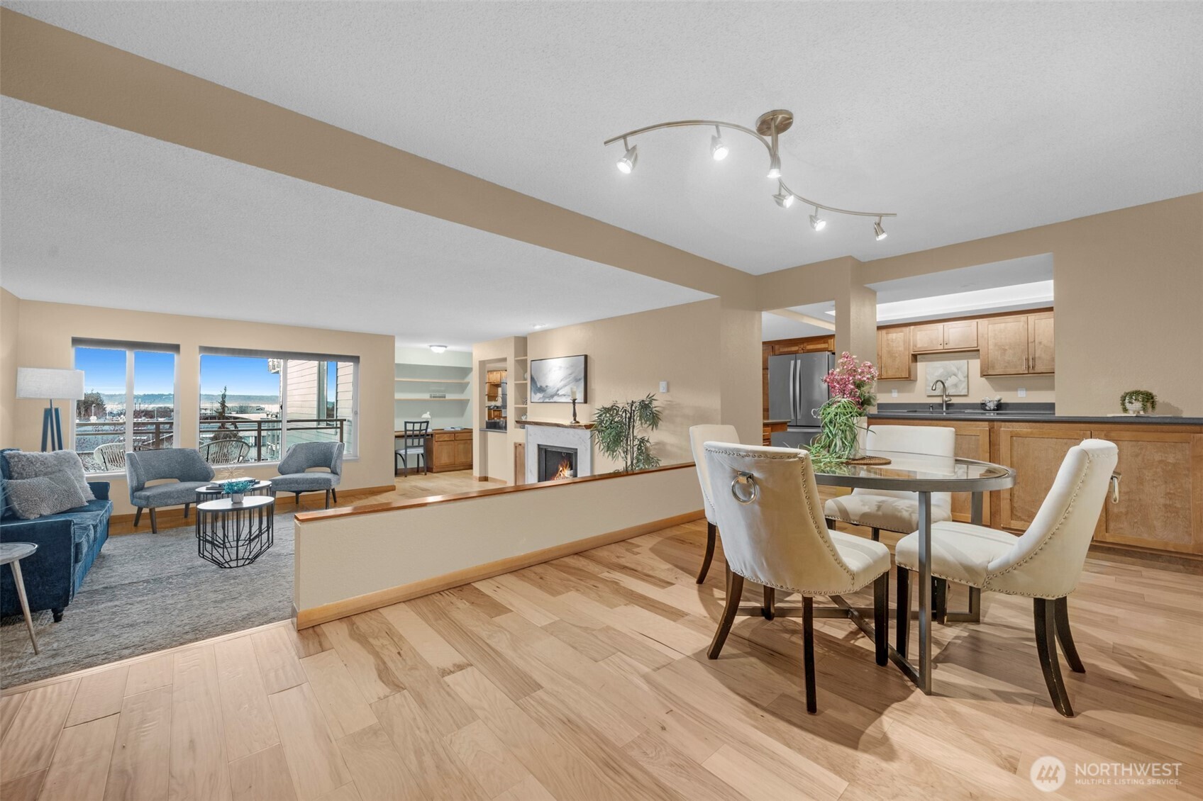 a dining room with furniture and a kitchen view
