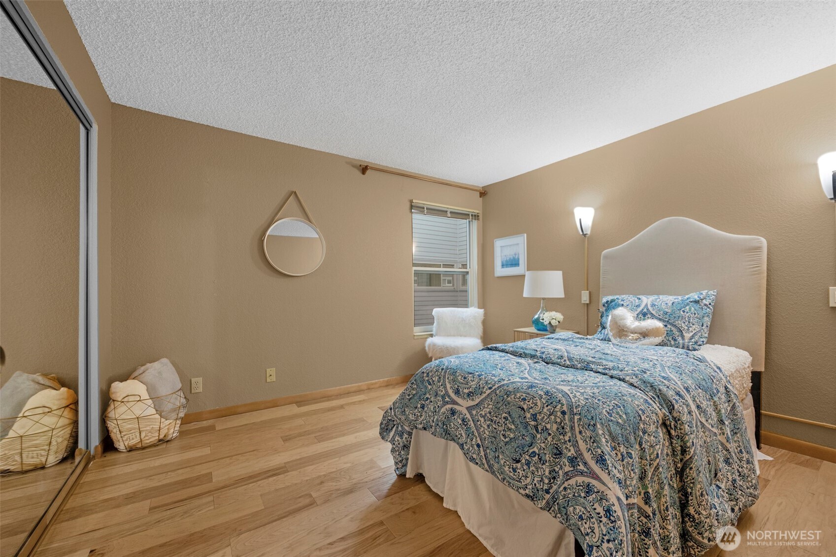 200 James Street, Unit 307 Edmonds, WA 98020 - Photo 16 of 37 a bedroom with a bed and wooden floor
