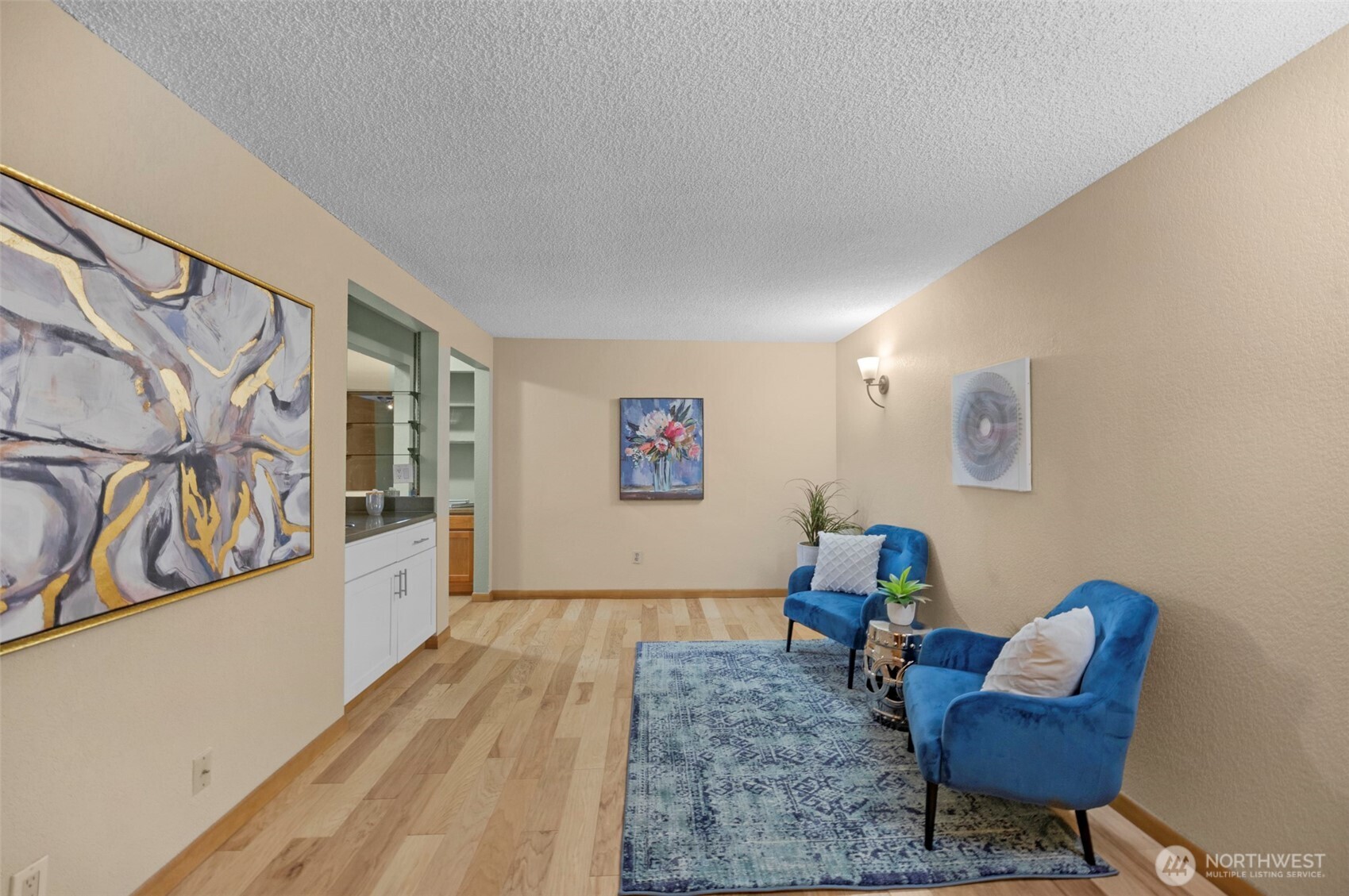 200 James Street, Unit 307 Edmonds, WA 98020 - Photo 20 of 37 a living room with furniture and a wooden floor