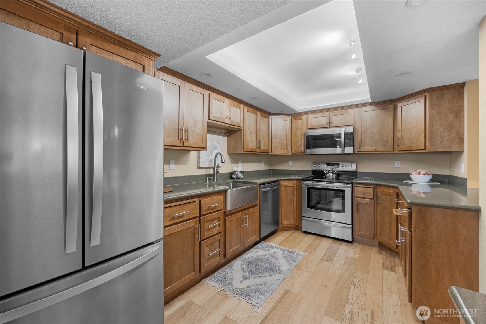 200 James Street, Unit 307 Edmonds, WA 98020 - Photo 22 of 37 a kitchen with granite countertop a refrigerator stove top oven and sink