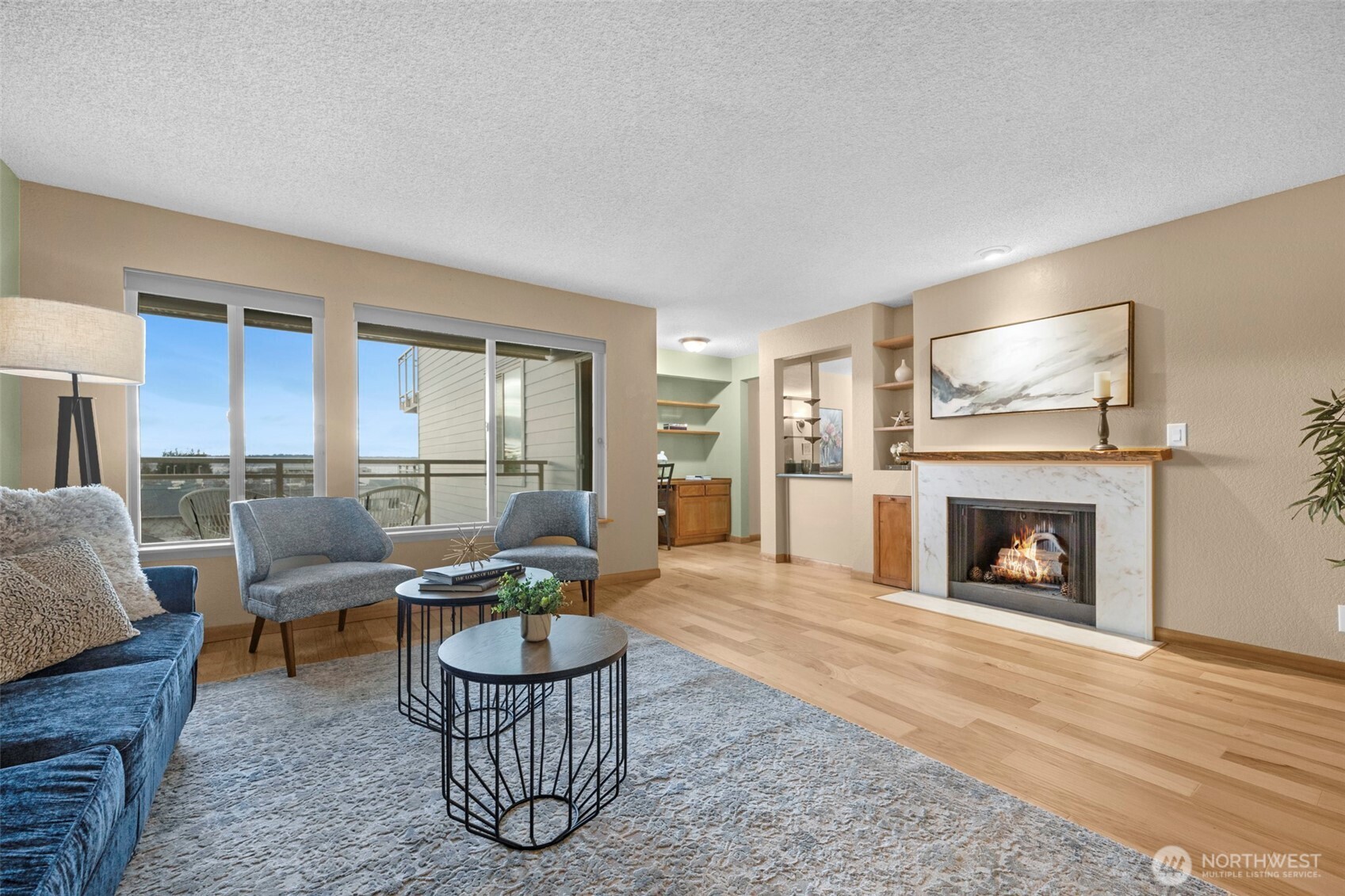 200 James Street, Unit 307 Edmonds, WA 98020 - Photo 3 of 37 a living room with furniture a fireplace and a table