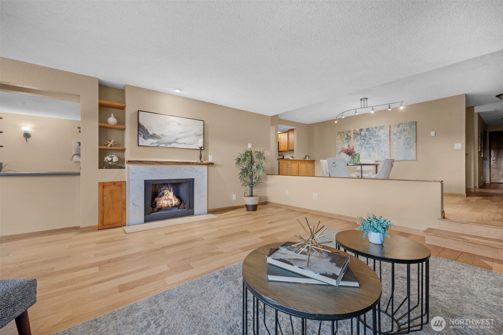 200 James Street, Unit 307 Edmonds, WA 98020 - Photo 5 of 37 a living room with furniture a fireplace and a table