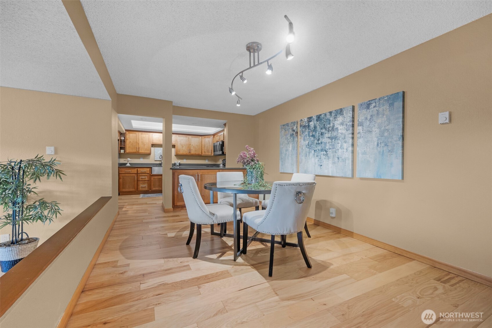 200 James Street, Unit 307 Edmonds, WA 98020 - Photo 6 of 37 a dining room with furniture potted plants and wooden floor