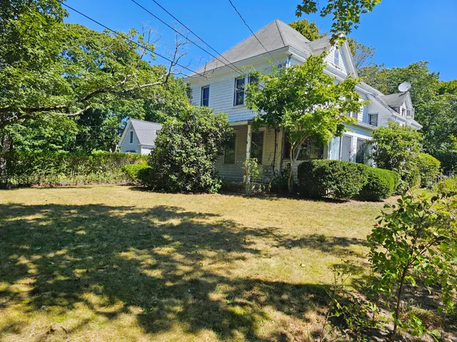 a view of yellow house with a yard
