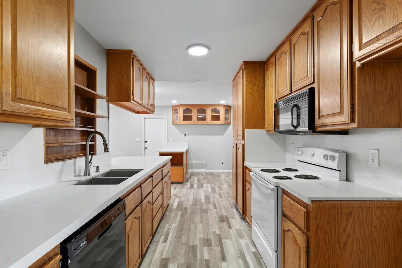1460 Ridgecrest Drive Manteca, CA 95336 - Photo 11 of 54 a kitchen with stainless steel appliances a sink stove top oven and cabinets