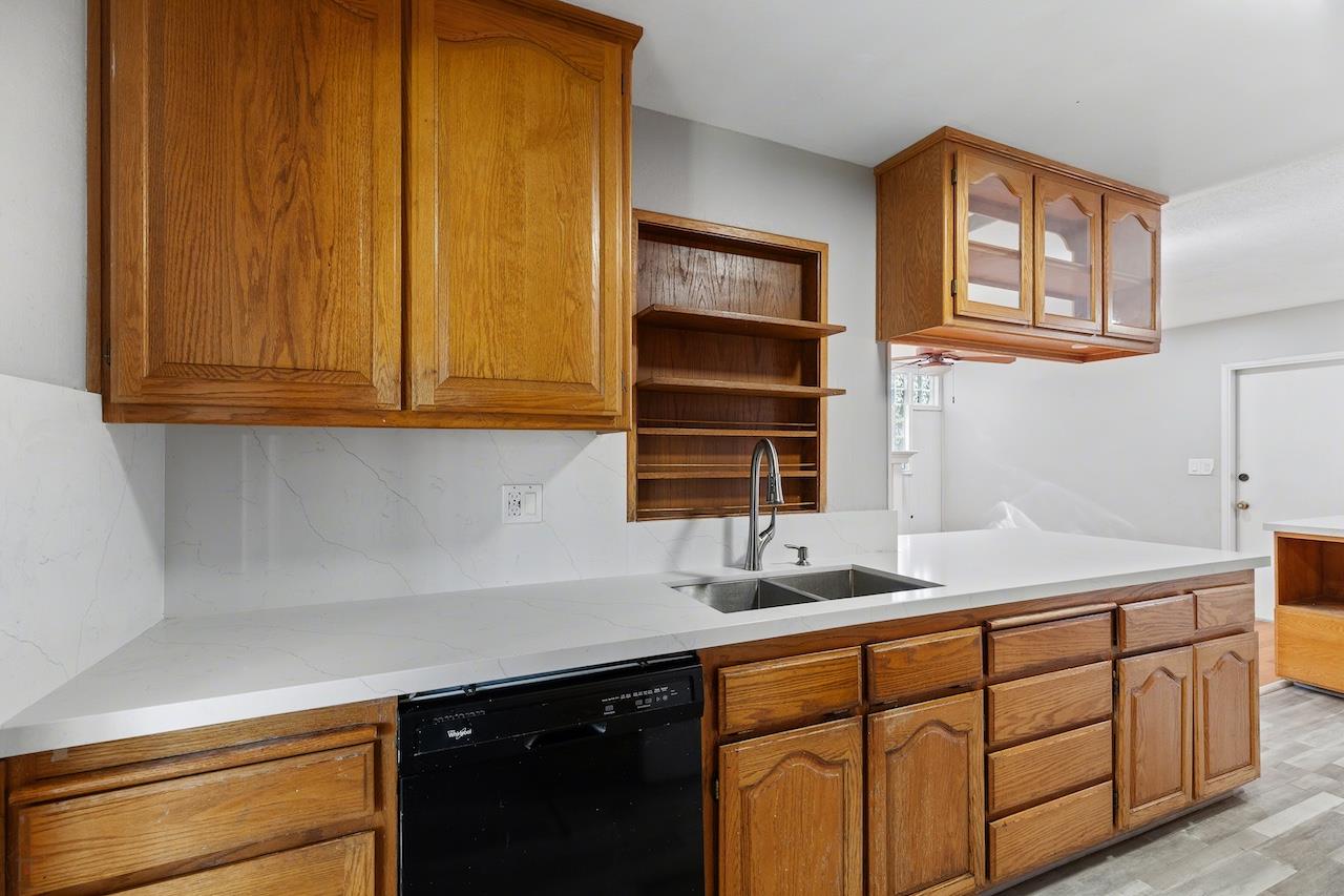 1460 Ridgecrest Drive Manteca, CA 95336 - Photo 12 of 54 a kitchen with stainless steel appliances granite countertop a sink a stove and cabinets