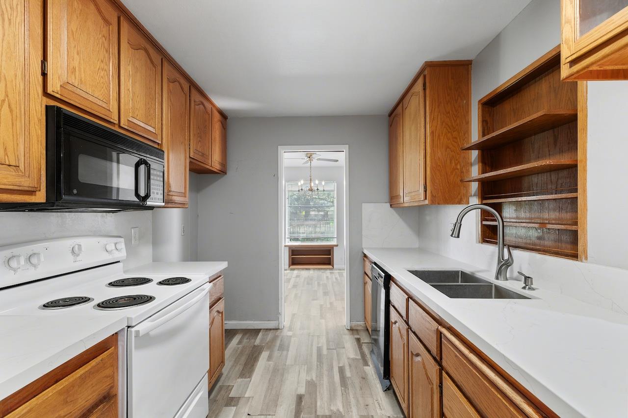 1460 Ridgecrest Drive Manteca, CA 95336 - Photo 13 of 54 a kitchen with a sink a stove and cabinets