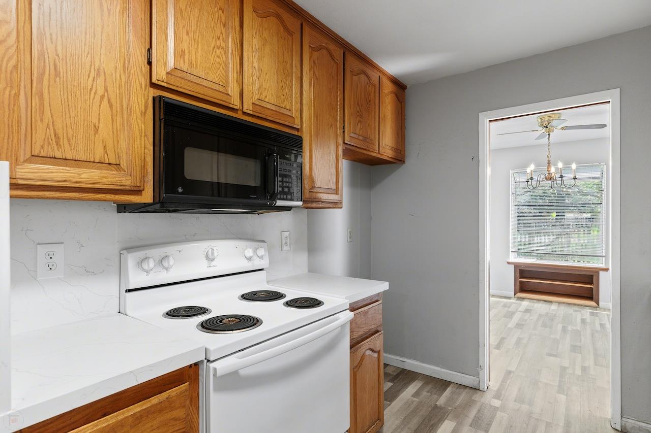 1460 Ridgecrest Drive Manteca, CA 95336 - Photo 14 of 54 a kitchen with a stove and a microwave