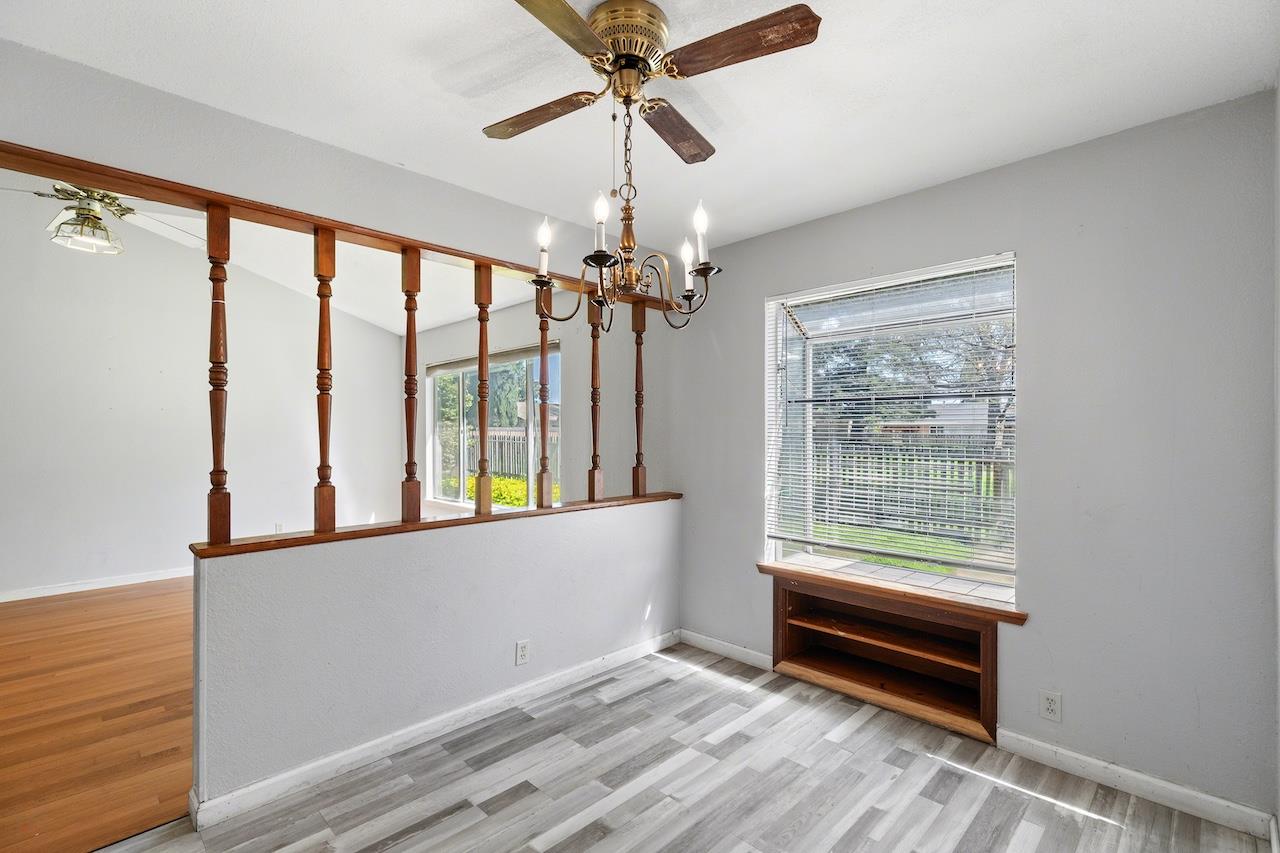1460 Ridgecrest Drive Manteca, CA 95336 - Photo 19 of 54 a view of a room with wooden floor and chandelier