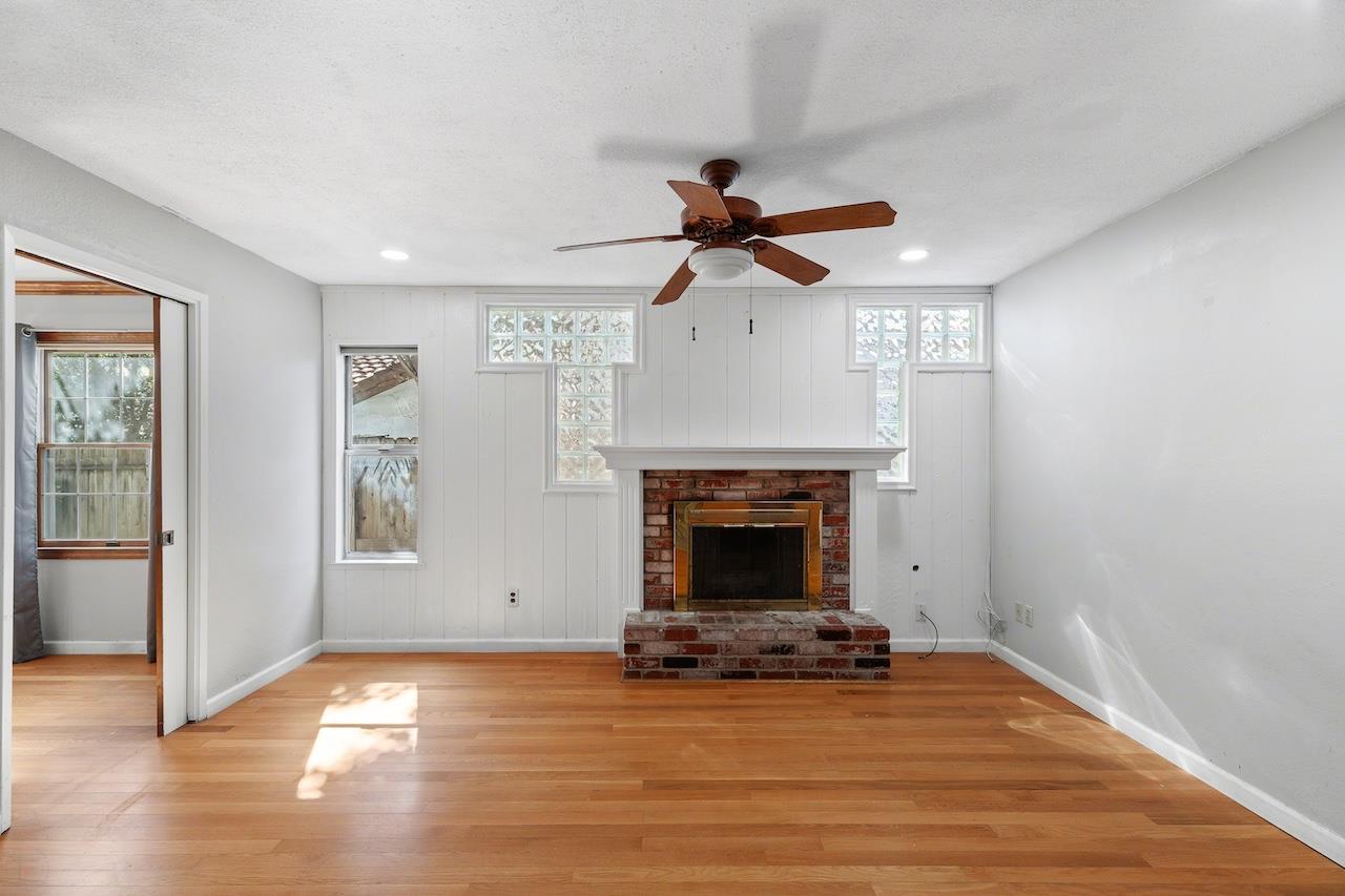 1460 Ridgecrest Drive Manteca, CA 95336 - Photo 21 of 54 a view of a livingroom with wooden floor a fireplace and window