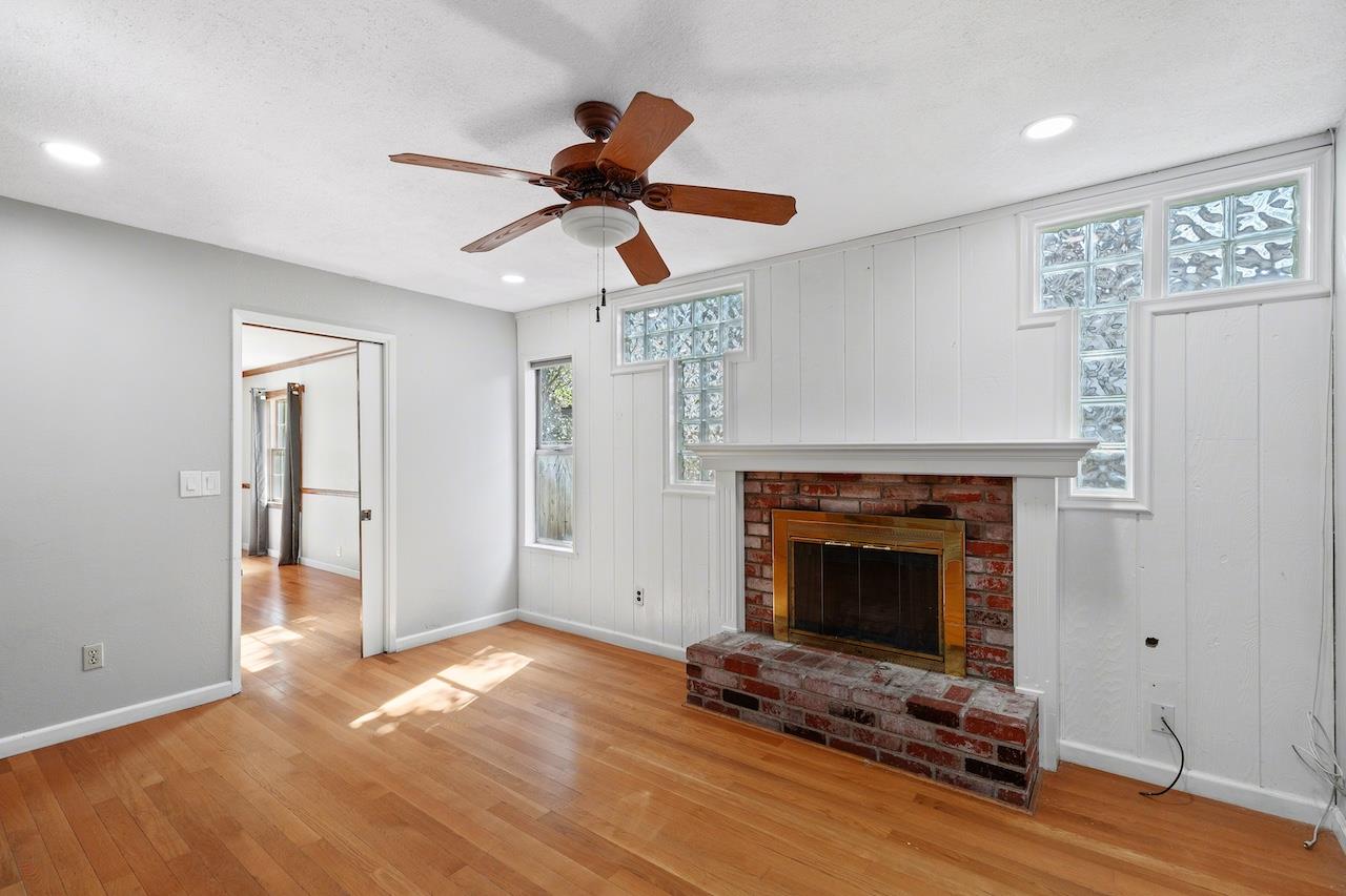 1460 Ridgecrest Drive Manteca, CA 95336 - Photo 22 of 54 a view of an empty room with wooden floor and a fireplace