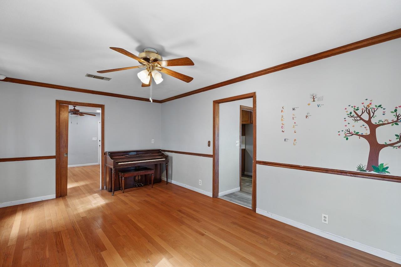 1460 Ridgecrest Drive Manteca, CA 95336 - Photo 27 of 54 a view of empty room with wooden floor and fan