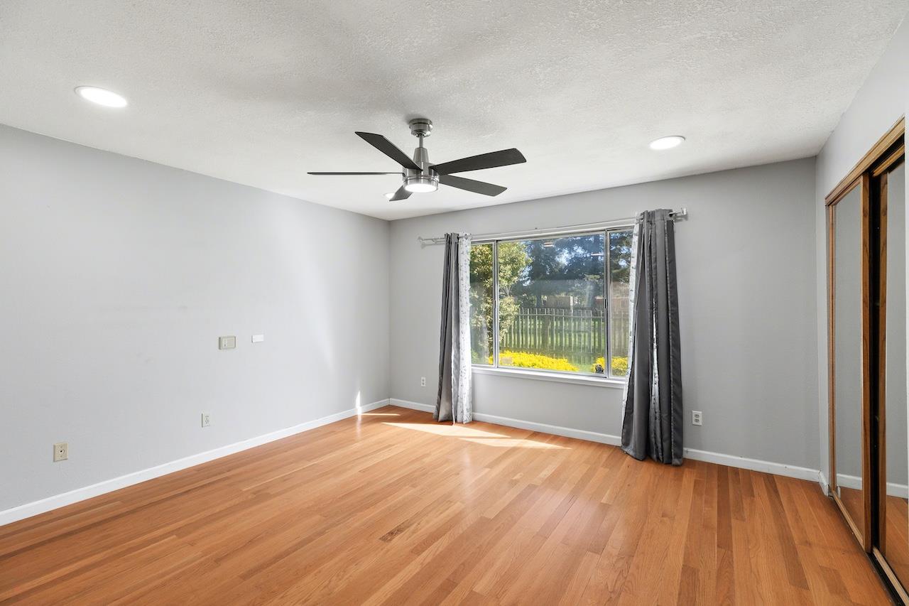 1460 Ridgecrest Drive Manteca, CA 95336 - Photo 31 of 54 an empty room with wooden floor and ceiling fan
