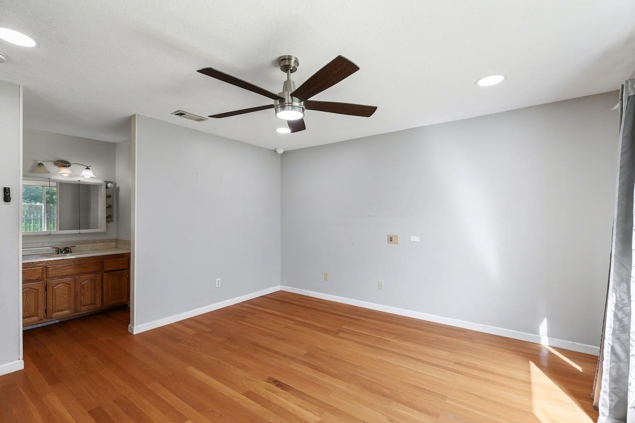 1460 Ridgecrest Drive Manteca, CA 95336 - Photo 33 of 54 an empty room with wooden floor and windows