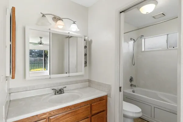 a white bath tub sitting next to a toilet