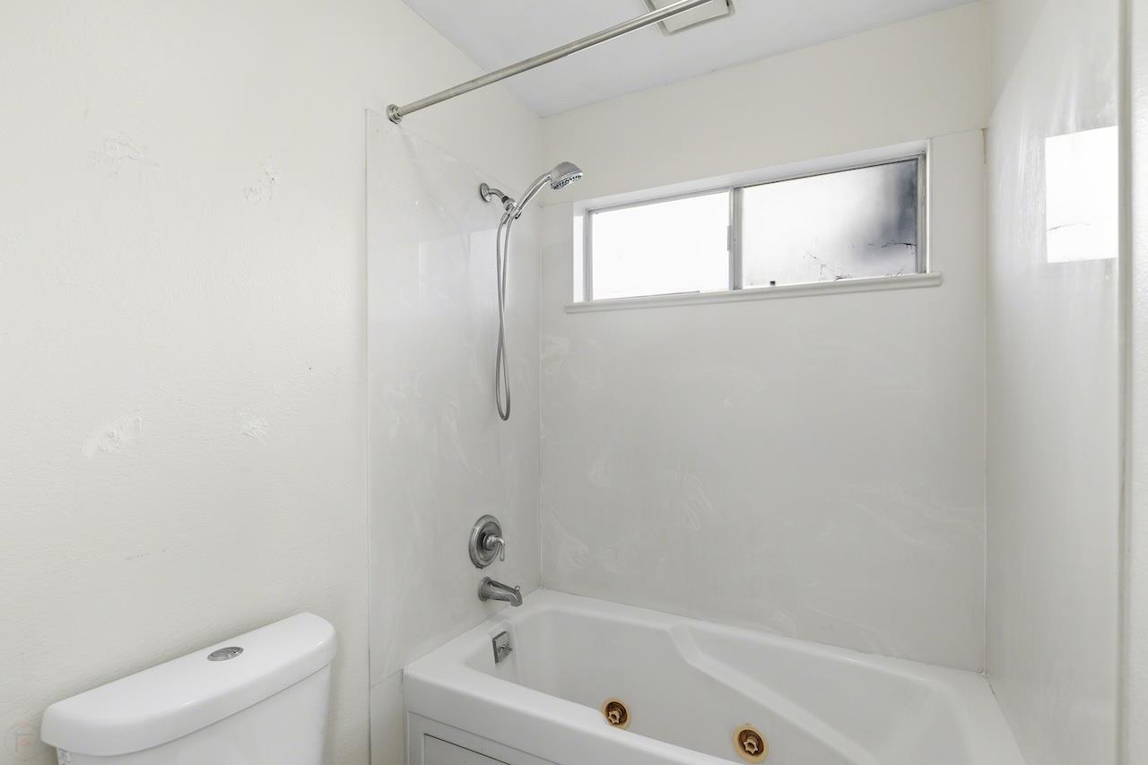 1460 Ridgecrest Drive Manteca, CA 95336 - Photo 35 of 54 a white bath tub sitting next to a toilet