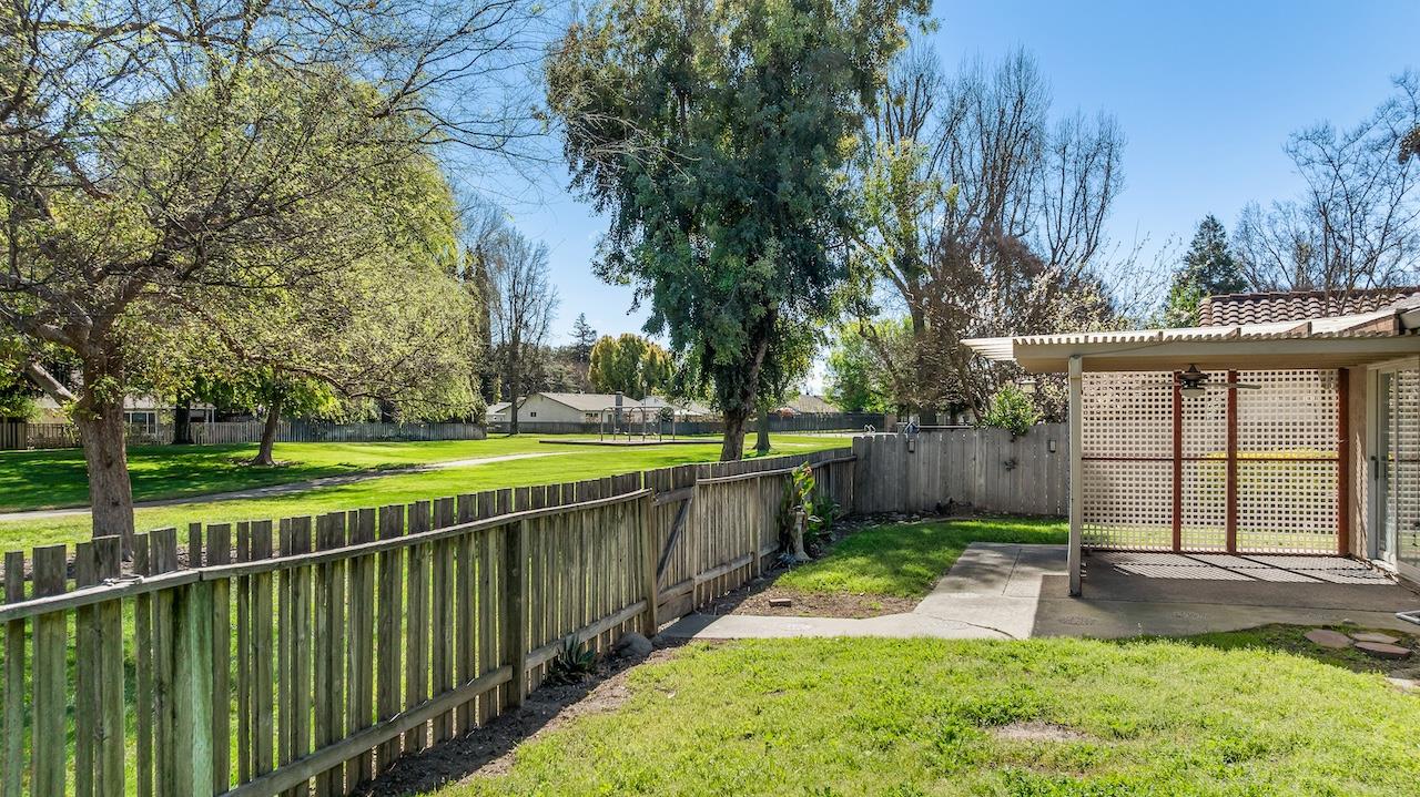 1460 Ridgecrest Drive Manteca, CA 95336 - Photo 43 of 54 a view of a backyard with large trees and wooden fence