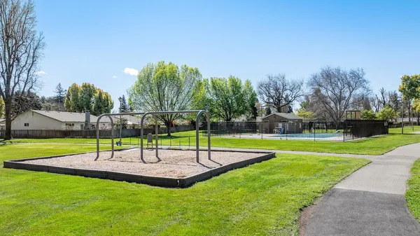a view of a yard with a wooden fence and a small yard