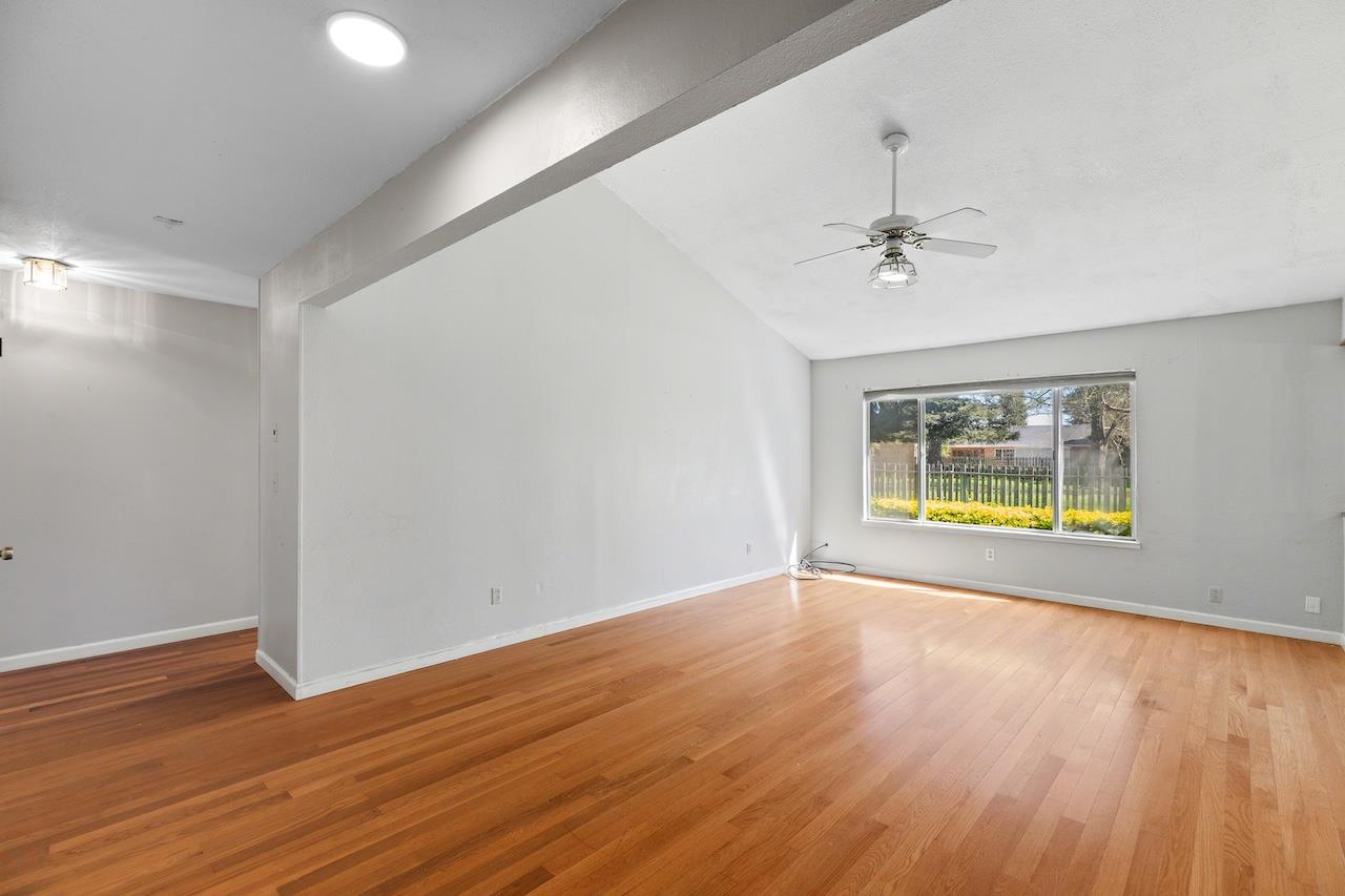 1460 Ridgecrest Drive Manteca, CA 95336 - Photo 7 of 54 a view of an empty room with wooden floor and a window