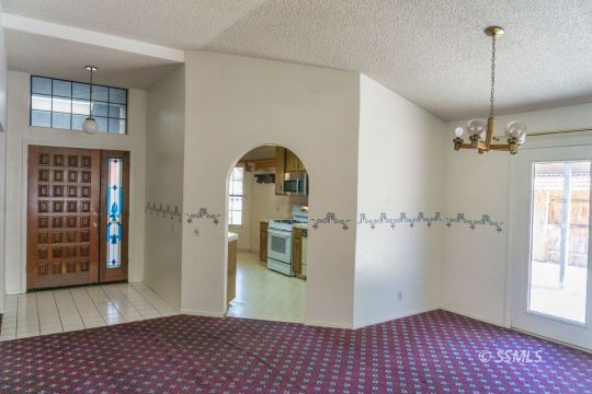 241 West Yellowstone Place Ridgecrest, CA 93555 - Photo 12 of 31 a view of a hallway with windows and chandelier