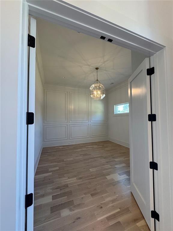 3425 Thompson Mill Road Buford, GA 30519 - Photo 24 of 48 a view of a hallway with wooden floor and chandelier