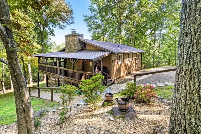 a view of a patio with furniture and a garden