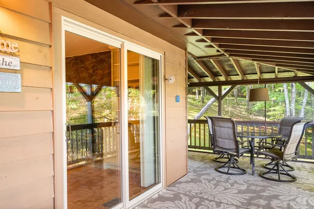 a view of a patio with table and chairs and wooden floor