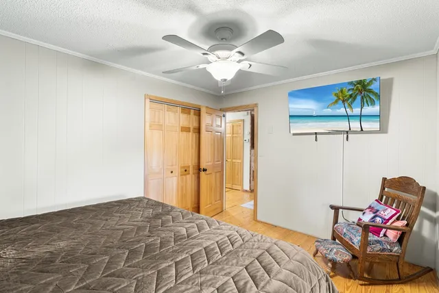 a bedroom with a bed and chandelier