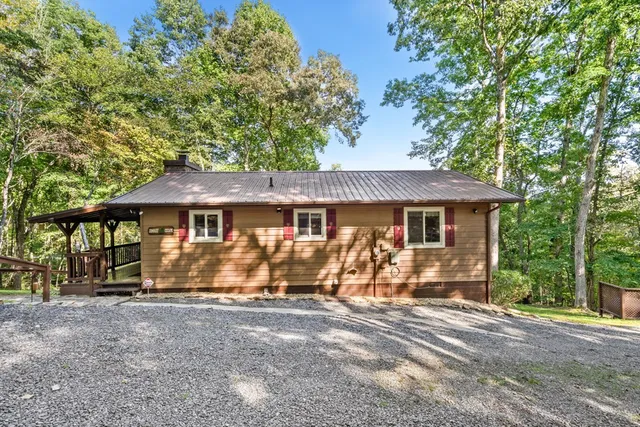 front view of a house with a large tree