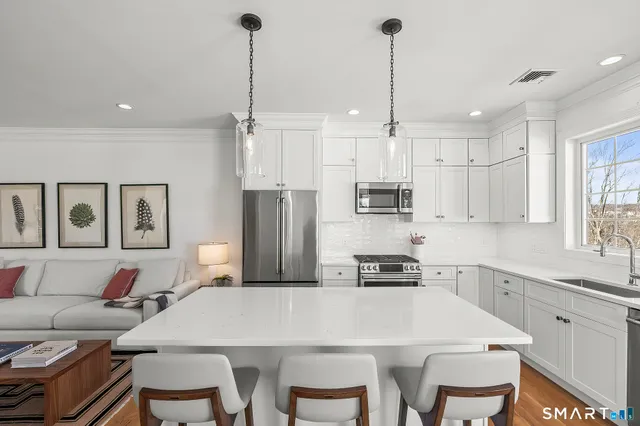 a kitchen with white cabinets and a stove
